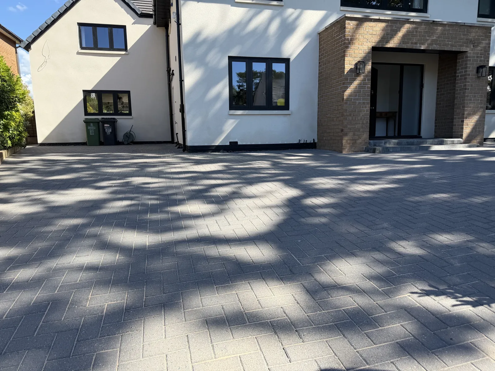 Clean grey block paving driveway outside a modern Cheshire property