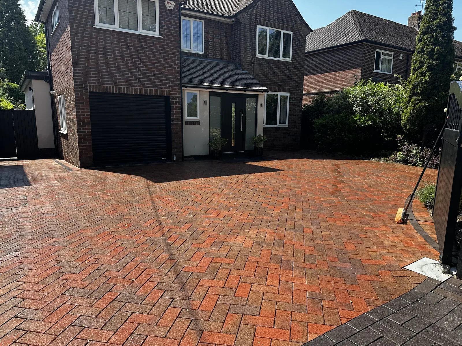 Restored red block paving driveway after professional cleaning near Kidsgrove