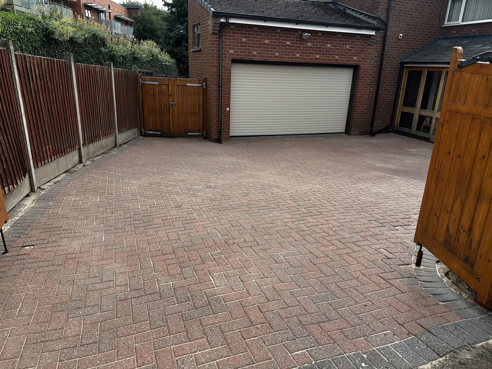 Cleaned block paving driveway leading to a residential garage