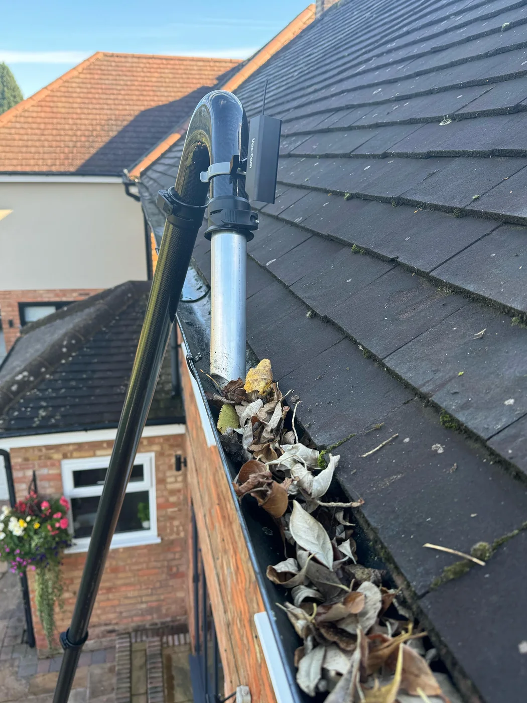 Vacuum equipment working through a heavily blocked gutter in Holmes Chapel