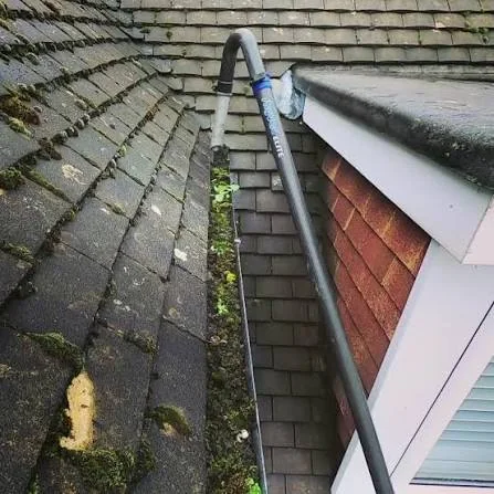 High-reach gutter vacuum positioned to clear a residential gutter in Holmes Chapel