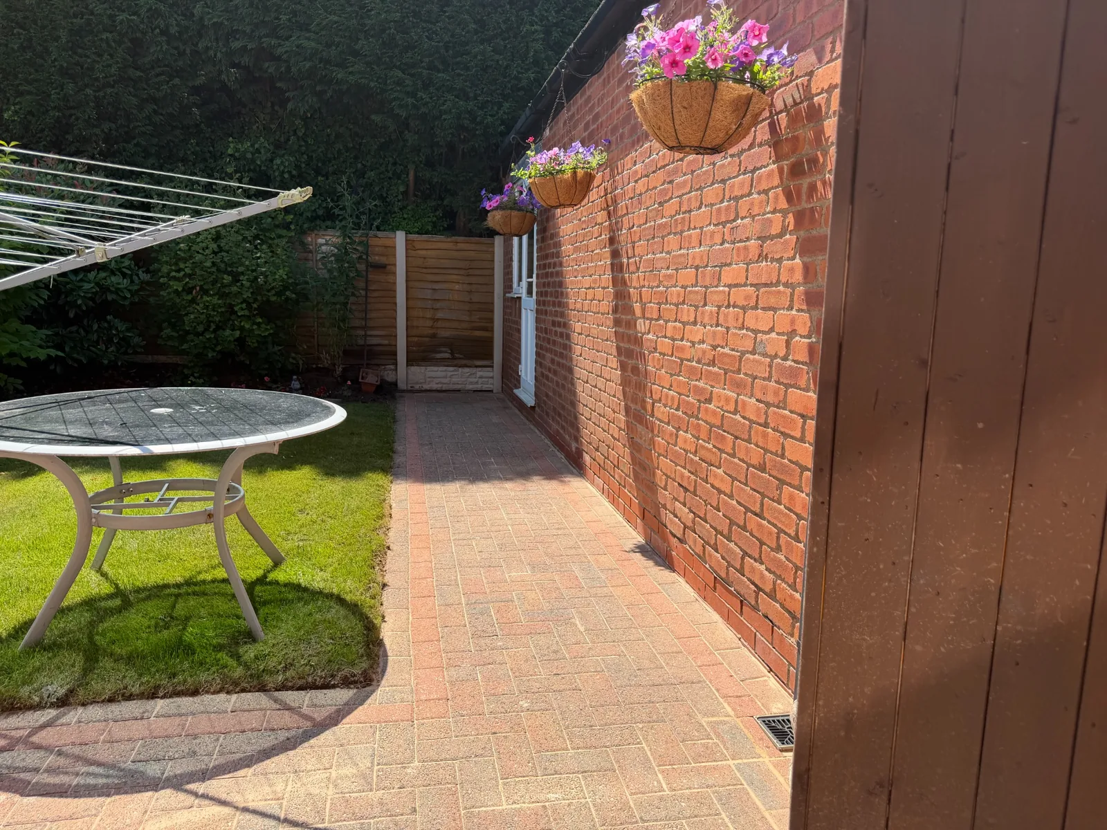 Clean block-paved garden path and patio area completed by Proline Exterior Cleaning