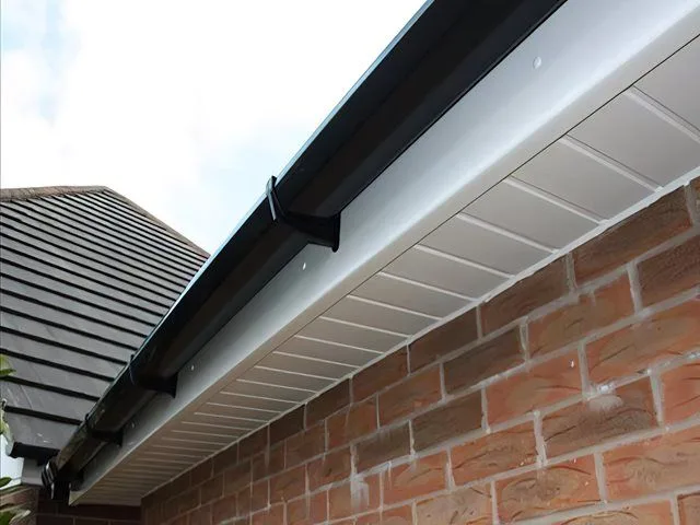 Black guttering with clean white soffits - soffit and fascia cleaning in Macclesfield
